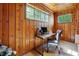 Wood-paneled office with multiple windows and a desk with a modern computer setup at 785 Alice St, Forest Park, GA 30297