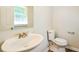 Bathroom featuring a sink with gold faucet and toilet at 1237 Gale Dr, Norcross, GA 30093