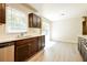 Bright kitchen with dark cabinets, stainless steel dishwasher, and window over the sink at 1237 Gale Dr, Norcross, GA 30093