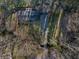 An aerial view of the property surrounded by trees and a long driveway at 1351 Stephens Sw St, Lilburn, GA 30047