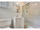 This bathroom has a stand up shower with glass doors and a white vanity at 1351 Stephens Sw St, Lilburn, GA 30047