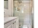 This bathroom has a stand up shower with glass doors and a white vanity at 1351 Stephens Sw St, Lilburn, GA 30047
