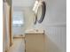 This is a bathroom with a sink, and a window with sheer curtains at 1351 Stephens Sw St, Lilburn, GA 30047