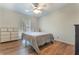 Bedroom with ceiling fan, gray comforter, and view of window at 1351 Stephens Sw St, Lilburn, GA 30047