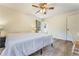 This bedroom has wood floors, large windows, neutral walls, and a ceiling fan at 1351 Stephens Sw St, Lilburn, GA 30047