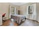 This bedroom features wood floors, natural light from the large windows, and a desk at 1351 Stephens Sw St, Lilburn, GA 30047