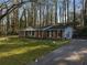 Beautiful brick home with a large front yard, mature trees, swing and a paved driveway at 1351 Stephens Sw St, Lilburn, GA 30047