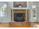 Close up view of the brick fireplace with wood burning stove and tv mounted above at 1351 Stephens Sw St, Lilburn, GA 30047