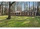 Charming brick home featuring a well-manicured lawn, classic columns, and inviting front porch swing at 1351 Stephens Sw St, Lilburn, GA 30047