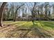 Spacious front yard of brick home featuring mature trees offering ample shade and curb appeal at 1351 Stephens Sw St, Lilburn, GA 30047