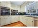 Charming kitchen with white cabinets, stainless steel appliances, and ample counter space at 1351 Stephens Sw St, Lilburn, GA 30047