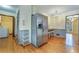 View of stainless steel refrigerator, wood floors, and entry into laundry room at 1351 Stephens Sw St, Lilburn, GA 30047
