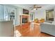 Spacious living room with fireplace, ceiling fan, and a combination of chairs and sofa at 1351 Stephens Sw St, Lilburn, GA 30047