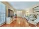 Cozy living room showcasing hardwood floors, large television, and comfortable seating arrangements at 1351 Stephens Sw St, Lilburn, GA 30047
