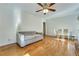 Open-concept living room and dining area with ceiling fan and hardwood floors at 1351 Stephens Sw St, Lilburn, GA 30047