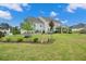 Expansive backyard with lush lawn, garden beds and mature landscaping at 2127 Harmony Dr, Canton, GA 30115
