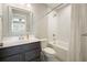 Updated bathroom features tile surround, tub and shower combination, and neutral paint at 2127 Harmony Dr, Canton, GA 30115