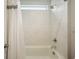 Bathroom features tile surround, tub and shower combination, and neutral paint at 2127 Harmony Dr, Canton, GA 30115