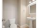 Powder room with pedestal sink, neutral walls, and fixtures creating a calm, welcoming space at 2127 Harmony Dr, Canton, GA 30115