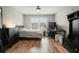 Cozy bedroom features a ceiling fan, hardwood floors, and a full size bed at 2127 Harmony Dr, Canton, GA 30115