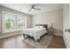 Bright bedroom with hardwood floors features a ceiling fan and large window with shutters at 2127 Harmony Dr, Canton, GA 30115