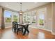 Bright dining area with large windows, a modern chandelier, and a dark wooden table with chairs at 2127 Harmony Dr, Canton, GA 30115