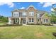 Beautiful two-story home featuring a brick facade, inviting front porch, and a well-manicured lawn at 2127 Harmony Dr, Canton, GA 30115