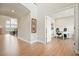 Bright hallway with hardwood floors and an office space featuring a modern desk and chair at 2127 Harmony Dr, Canton, GA 30115