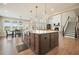 Bright, open kitchen with a large island, stainless steel appliances, and an adjacent dining area at 2127 Harmony Dr, Canton, GA 30115