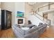 Inviting living room with a fireplace, large sectional sofa, and staircase access to the upper level at 2127 Harmony Dr, Canton, GA 30115