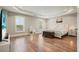 Bright main bedroom showcasing large windows, hardwood floors, and tray ceilings at 2127 Harmony Dr, Canton, GA 30115