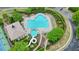 Aerial view of a community pool with a slide, lounge chairs, manicured landscaping, and a nearby clubhouse at 2127 Harmony Dr, Canton, GA 30115