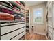 Spacious walk-in closet with drawers, shelves, mirror, and natural light at 2127 Harmony Dr, Canton, GA 30115