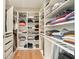 Well-organized walk-in closet with custom shelving and ample storage space at 2127 Harmony Dr, Canton, GA 30115