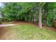 Spacious backyard with green lawn, mature trees, and partial fencing at 4805 Wilkie Nw Way, Acworth, GA 30102