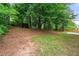 Sloping backyard with mature trees and partial fencing at 4805 Wilkie Nw Way, Acworth, GA 30102