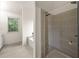 Modern bathroom featuring tiled floors, glass shower and soaking tub beside a large window at 4805 Wilkie Nw Way, Acworth, GA 30102