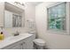 Bathroom featuring a single vanity, a window, and a shower tub combo with shower curtain at 4805 Wilkie Nw Way, Acworth, GA 30102