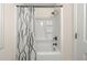 Bright bathroom featuring a shower with a decorative curtain and bronze fixtures at 4805 Wilkie Nw Way, Acworth, GA 30102