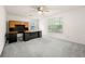 Bedroom with grey carpet, windows, ceiling fan and a large desk area with built in storage at 4805 Wilkie Nw Way, Acworth, GA 30102