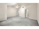 Large open bedroom featuring neutral carpet, white walls, ceiling fan and doors to other rooms at 4805 Wilkie Nw Way, Acworth, GA 30102