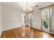 Dining room featuring wood floors, neutral walls, bright natural light, and updated chandelier at 4805 Wilkie Nw Way, Acworth, GA 30102
