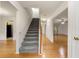 Inviting foyer featuring hardwood floors, a staircase, and views into the living spaces at 4805 Wilkie Nw Way, Acworth, GA 30102