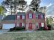 Charming brick home featuring red shutters, landscaped yard, and an attached two-car garage at 4805 Wilkie Nw Way, Acworth, GA 30102