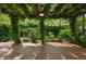 Backyard featuring a wood deck and a pergola covered in lush vines at 2930 Winchester Dr, Cumming, GA 30041