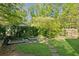 Backyard featuring a manicured lawn, paver pathway, and garden beds at 2930 Winchester Dr, Cumming, GA 30041