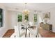 Dining room with a glass table, hardwood floors, and french doors leading to the outdoors at 2930 Winchester Dr, Cumming, GA 30041