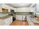 Updated kitchen with white cabinetry, granite countertops, and stainless steel appliances at 2930 Winchester Dr, Cumming, GA 30041