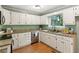 Bright kitchen with white cabinets, granite countertops, and stainless steel appliances at 2930 Winchester Dr, Cumming, GA 30041