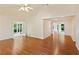Spacious living room with hardwood floors, a ceiling fan, and double doors to the sunroom at 2930 Winchester Dr, Cumming, GA 30041